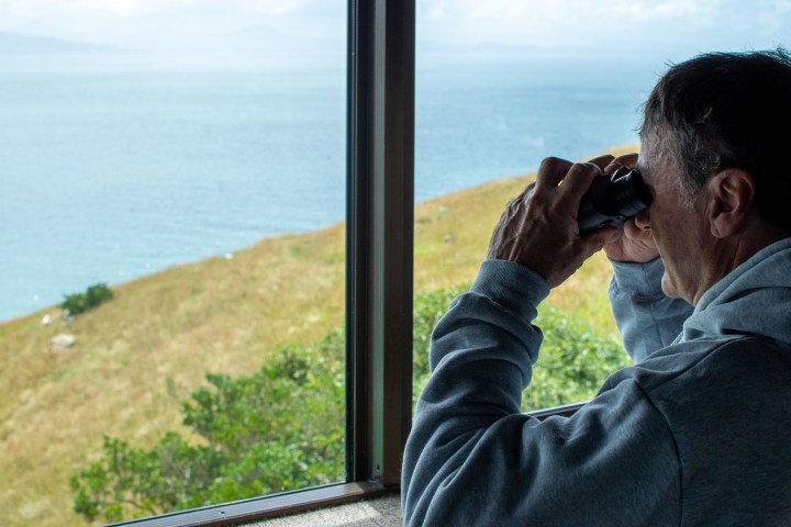a man standing in front of a body of water